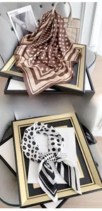 Polished silk scarf with chic polka dots and stripes, displayed with elegant accessories
