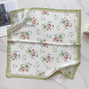 Detail of floral silk-feel 58cm square scarf with delicate green grid and pink blossoms