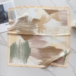 Close-up of abstract floral silk scarf with sleek satin finish and premium edge detailing