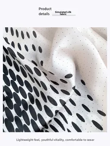 Detail showing smooth faux silk fabric texture with classic black polka dots on white