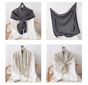 Detail of 90cm geometric satin scarf styled as a shawl over a white shirt
