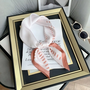 Polka dot silk-like square scarf in ivory and coral orange with stylish sunglasses