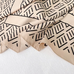 Elegant 90cm square silk scarf with beige base and black geometric pattern details