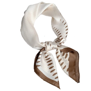 Elegant cream and brown polka dot silk square scarf tied in a stylish knot