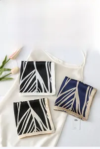 Detailed flat lay of striped imitation silk scarves with elegant tulip and card decor