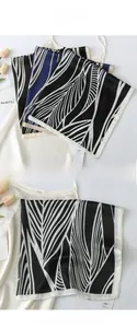 Detailed view of striped feather print silk scarf with fine hand-rolled edges
