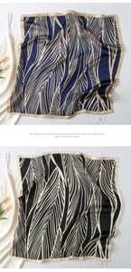 Detail of silk square scarves with leaf pattern on a white dress and tulips
