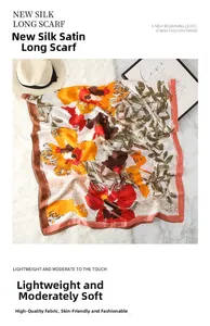 Detailed texture of oil painting floral silk scarf with vibrant orange and red flower print