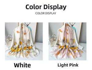 Detail of elegant satin scarves featuring yellow ginkgo prints in white and light pink