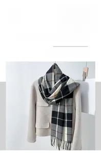 Detail of classic plaid scarf with fringes on beige coat, imitation cashmere texture