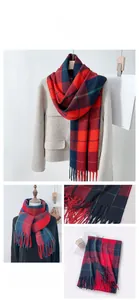 Detail view of British style red and blue plaid scarf with elegant tassels and warm texture