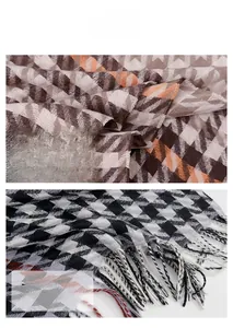 Close-up of houndstooth scarf texture with soft cashmere feel and delicate fringe details