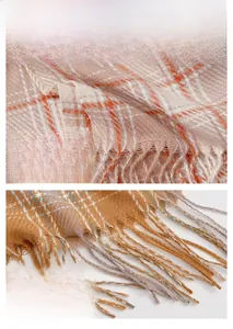 Close-up of orange plaid cashmere scarf showing knit texture and fringe tassels