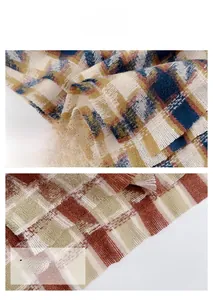 Close-up of houndstooth scarf fabric showing soft cashmere texture and delicate fringes