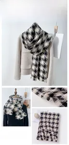 Detail of black and white houndstooth scarf showing soft texture and fringe edges