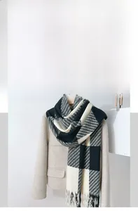 Detail of soft imitation cashmere scarf with classic plaid pattern and tassel fringe