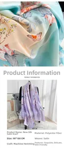 Close-up of floral butterfly print on satin scarf with smooth silk-like fabric texture