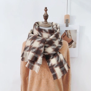 Classic houndstooth thick cashmere-like scarf in brown and white on a model stand