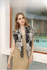Close-up of imitation velvet triangle scarf with elegant black and white rose floral prints