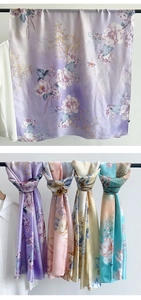 Detail of elegant satin floral scarves showing smooth silk texture and blooming peony prints