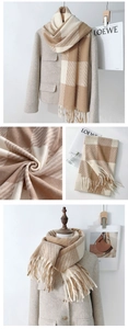 Detail of soft beige and coffee checkered scarf with thick fringe and twill weave texture