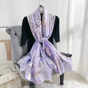 Elegant light purple floral silk scarf on a model with a soft artistic blossom pattern