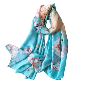 Elegant lake blue satin silk scarf with delicate floral print for women on white backdrop