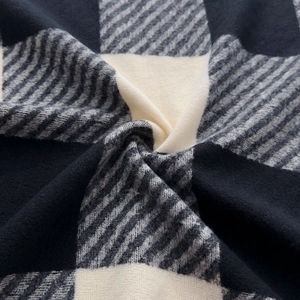 Classic black and white checkered cashmere-like scarf with thick knitted texture and tassels