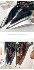 Detail of navy and tan printed triangle scarf showing elegant horse carriage pattern