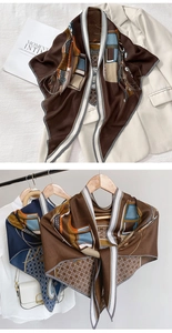 Detail of vintage carriage print scarf with geometric patterns and silk-like texture