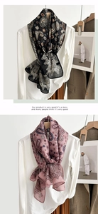 Detail of vintage paisley pattern scarves in black and purple with lightweight silk texture