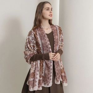 Elegant vintage linen scarf with bohemian paisley pattern shown on model in white studio