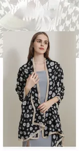 Detail shot of the cotton linen blend scarf with elegant black and white camellia pattern
