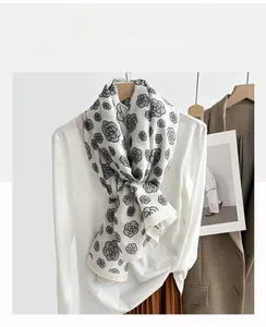 Close-up of lightweight camellia floral scarf with soft cotton feel and elegant drape