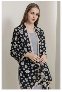 Detailed view of camellia flower pattern on the soft black and white cotton-linen shawl
