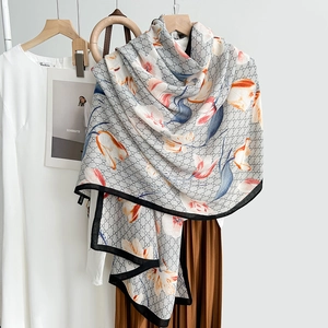 Elegant floral print shawl with geometric monogram pattern and black border trim