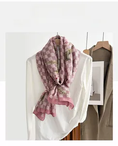 Detail shot of lightweight pink floral check scarf hanging on a hanger for daily styling