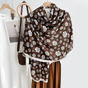 Elegant brown scarf featuring white camellia flower prints with a white border trim