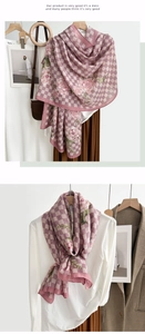 Detail of elegant pink floral plaid scarf showing lightweight texture and draped styling