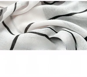 Macro shot of black and white camellia pattern scarf with breathable woven fiber texture