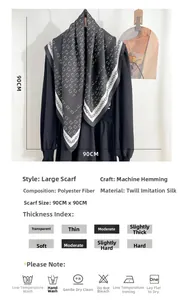 Detail showing grey chain and letter C pattern silk scarf with machine hem 90x90cm size