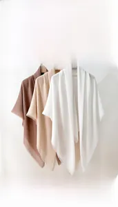 Detailed view of 130x130cm solid color square scarves with elegant frayed fringe edges