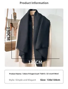 Detail of 130x130cm black frayed square scarf with elegant fringe edge on beige coat