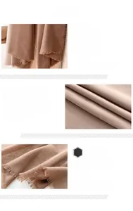 Close-up of brown scarf featuring soft texture and detailed frayed tassel edges