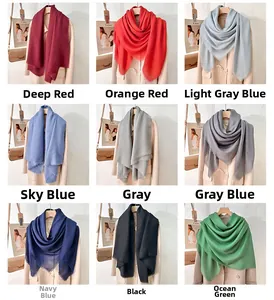 Detailed grid of soft cashmere-feel solid scarves in multiple colors with tassels