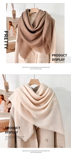 Detail of mercerized wool scarves in tan and cream with fine fringe on a beige coat