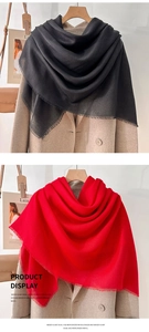 Detail of mercerized wool scarf in black and red with fine short fringes and soft texture
