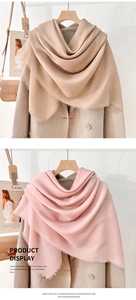 Detail of mercerized wool scarf showing beige and pink colors with soft fringe edges