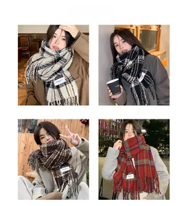 Detail shot of classic plaid pattern scarves with tassel fringe in multiple color options