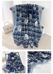 Dettaglio di sciarpa in cotone e lino blu navy con rose bianche e trama intrecciata